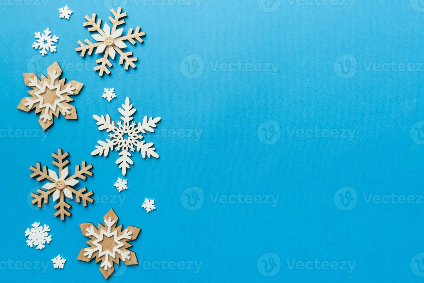 New Year composition white christmas snowflakes. Christmas decor background with pine cones. Top view with copy space photo