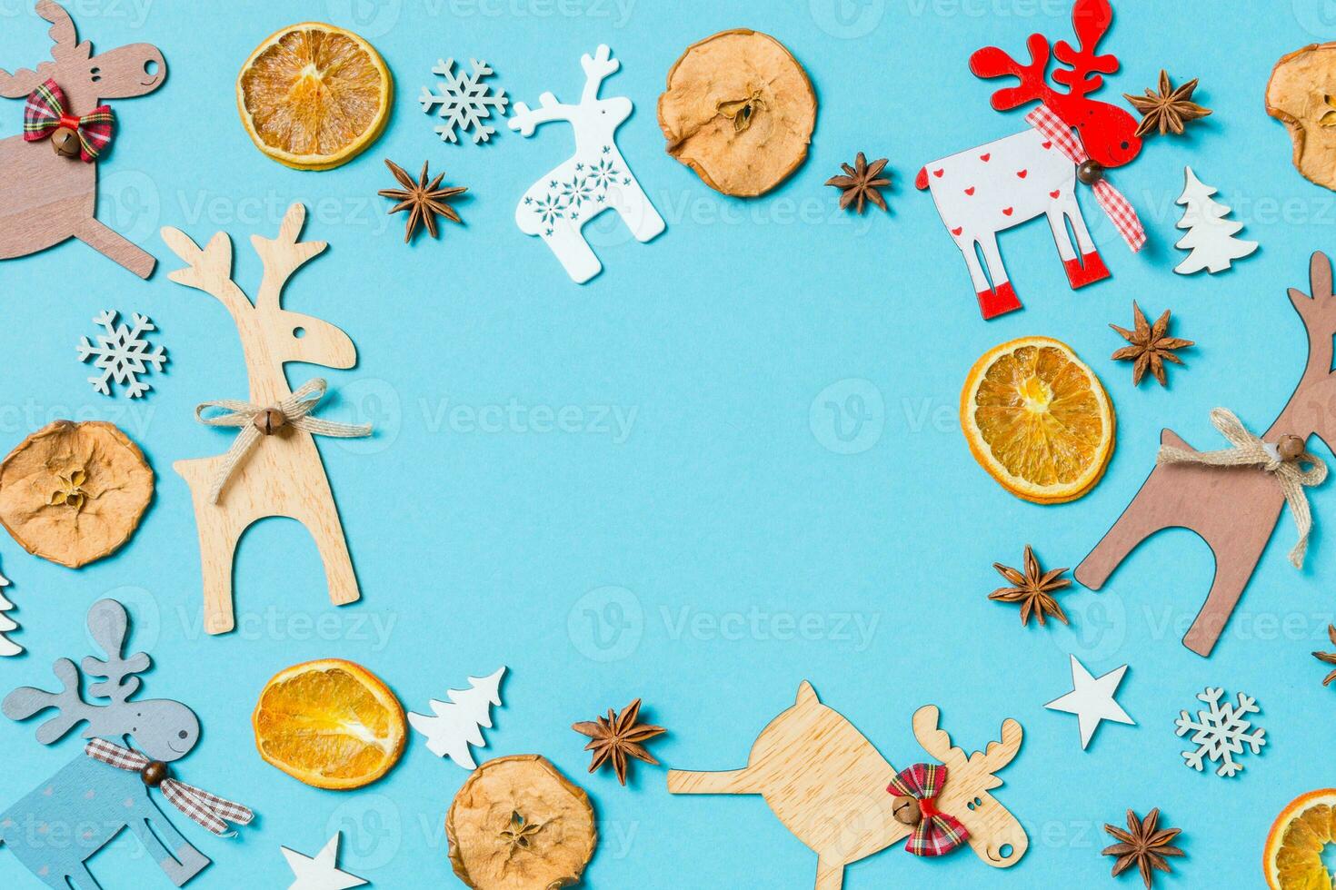 Top view of holiday decorations and toys on blue background. Christmas ornament concept with empty space for your design photo
