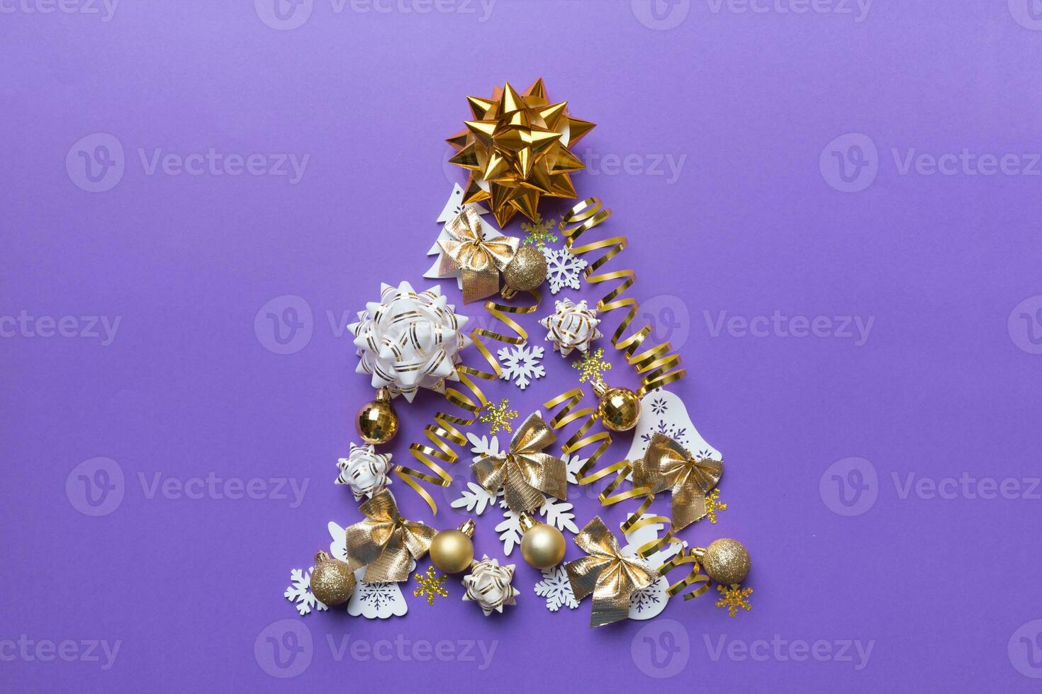 Christmas tree made from colored ball decoration on colored background, view from above. New Year minimal concept with copy space photo