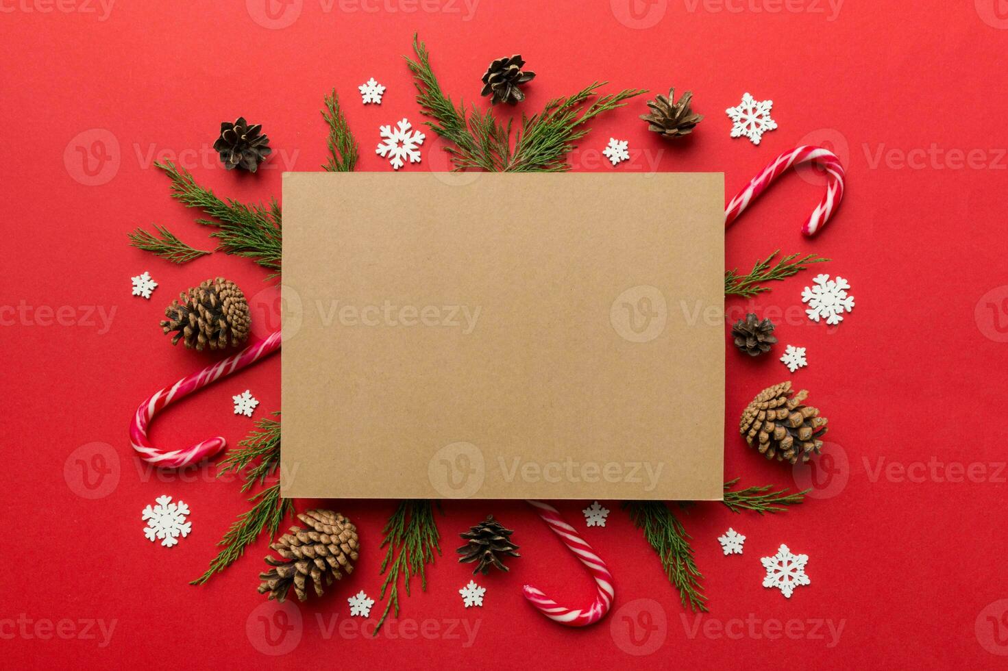 Flat lay Christmas composition. square Paper blank, pine tree branches, christmas decorations on Colored background. Top view, copy space for text photo