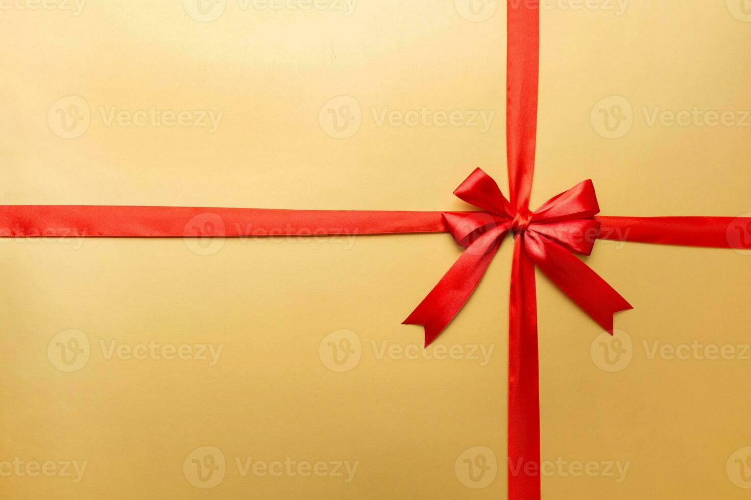 Top view of Red ribbon rolled and red bow isolated on colored background. Flat lay with copy space photo