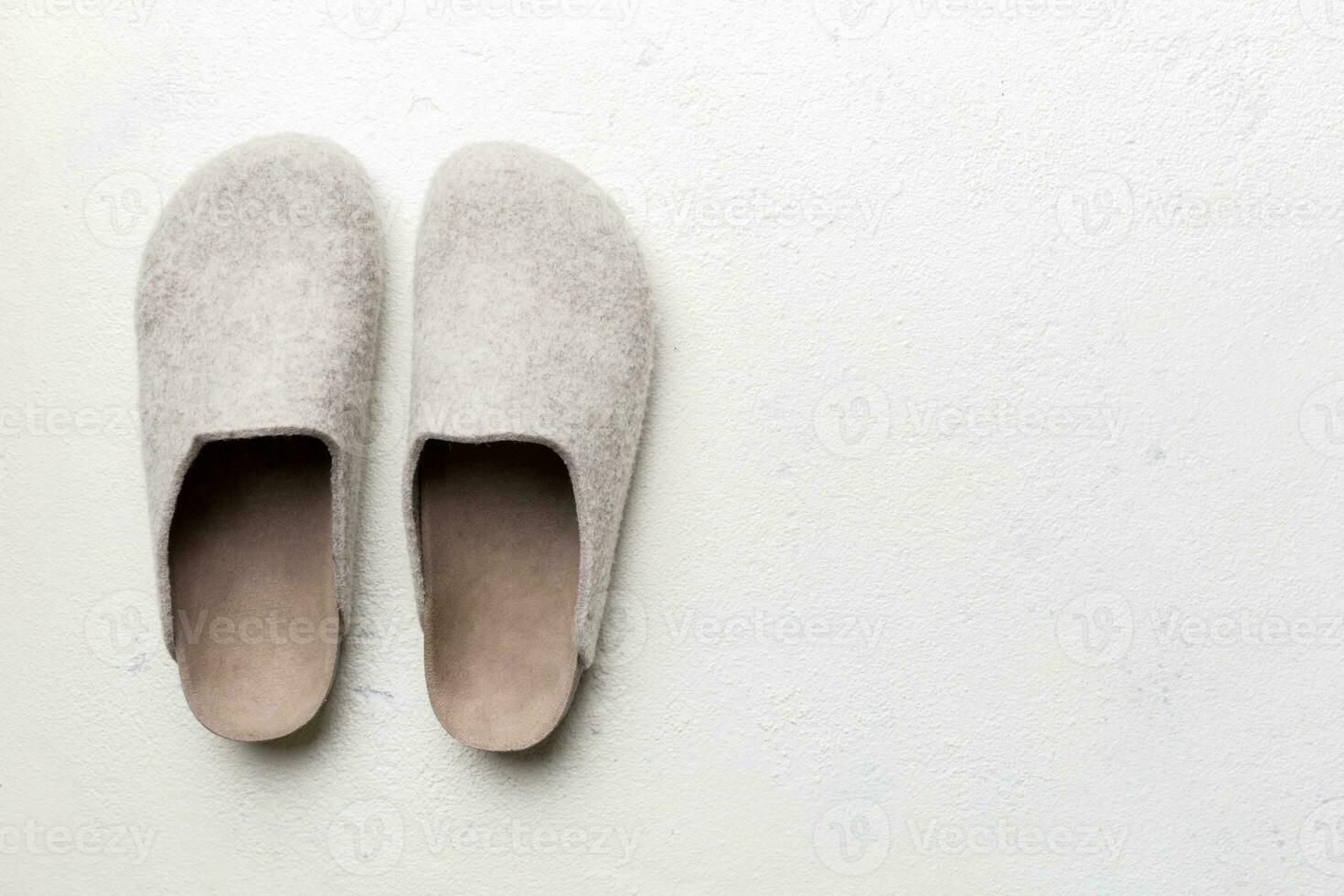 Warm winter women woolen slippers on colored background. Copy space for text photo