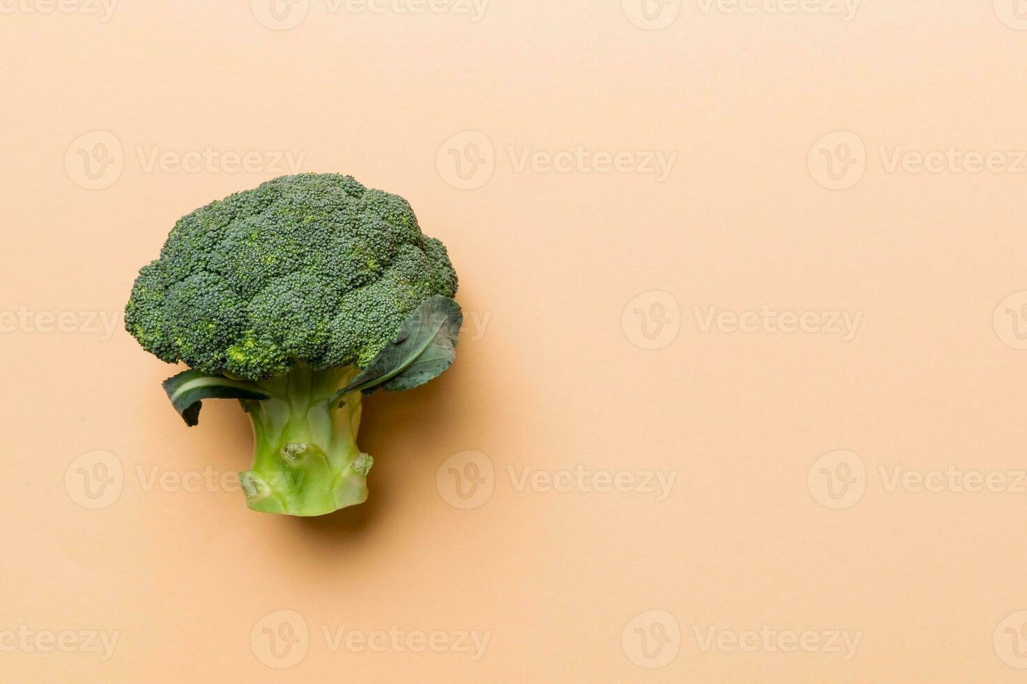 Top view fresh green broccoli vegetable on Colored background. Broccoli cabbage head Healthy or vegetarian food concept. Flat lay. Copy space photo