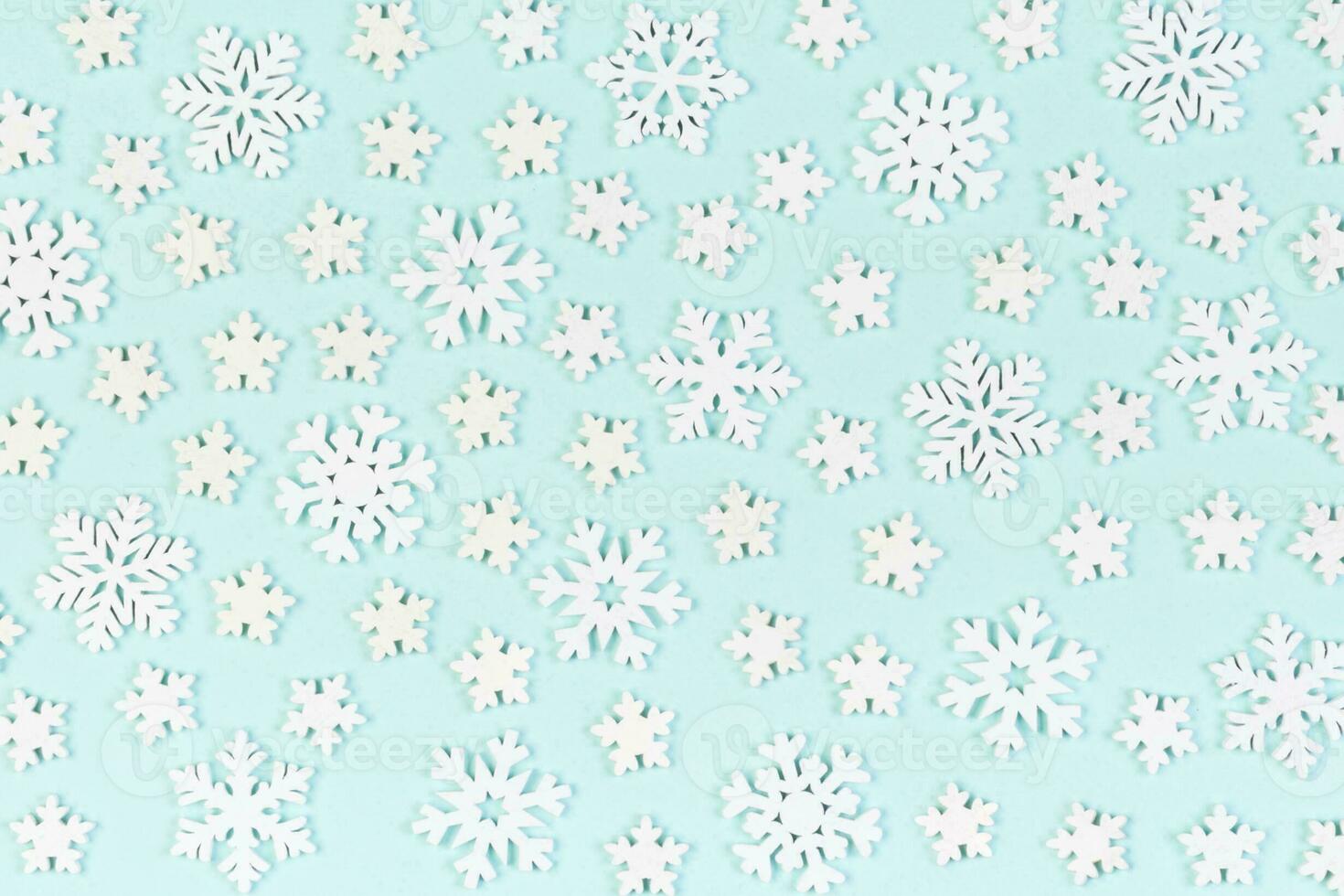 Set of white snowflakes on colorful background. Top view of Christmas ornament. New Year time concept with empty space for your design photo