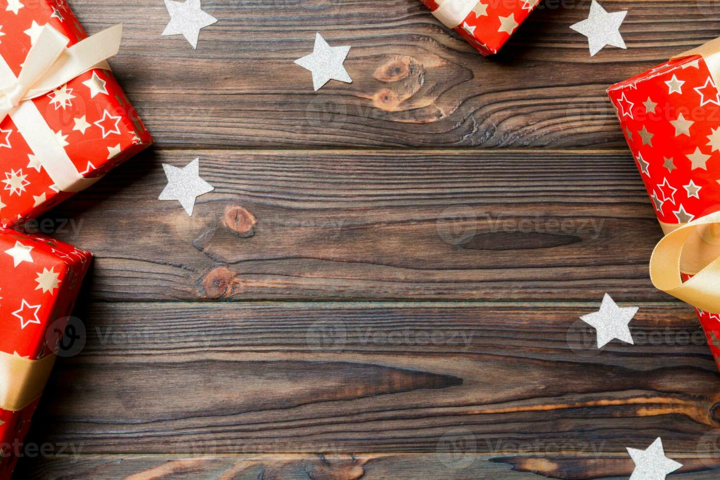 Top view of Christmas background made of gift boxes and snowflakes on wooden background. New year holiday concept with copy space photo