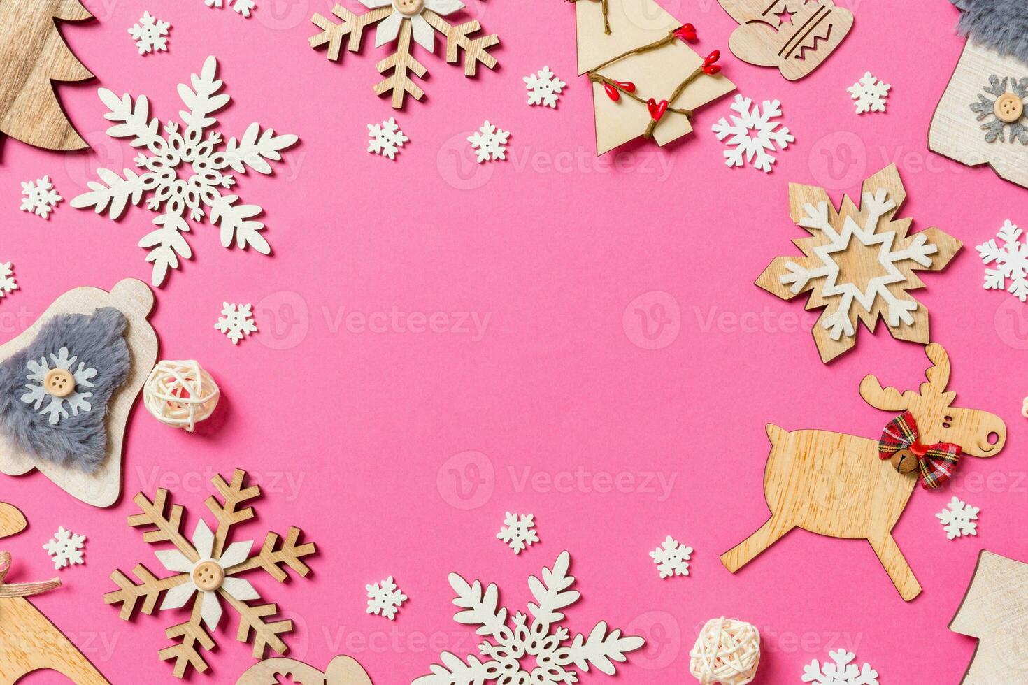 Top view of holiday decorations and toys on pink background. Christmas ornament concept with empty space for your design photo