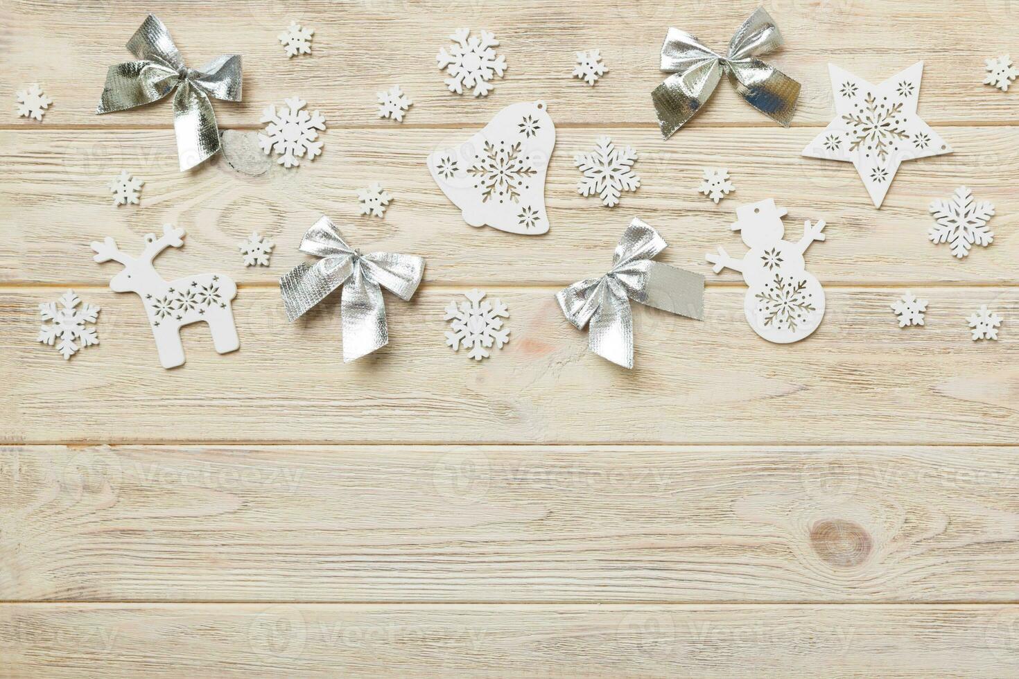 New Year composition white christmas snowflakes. Christmas decor background with pine cones. Top view with copy space photo