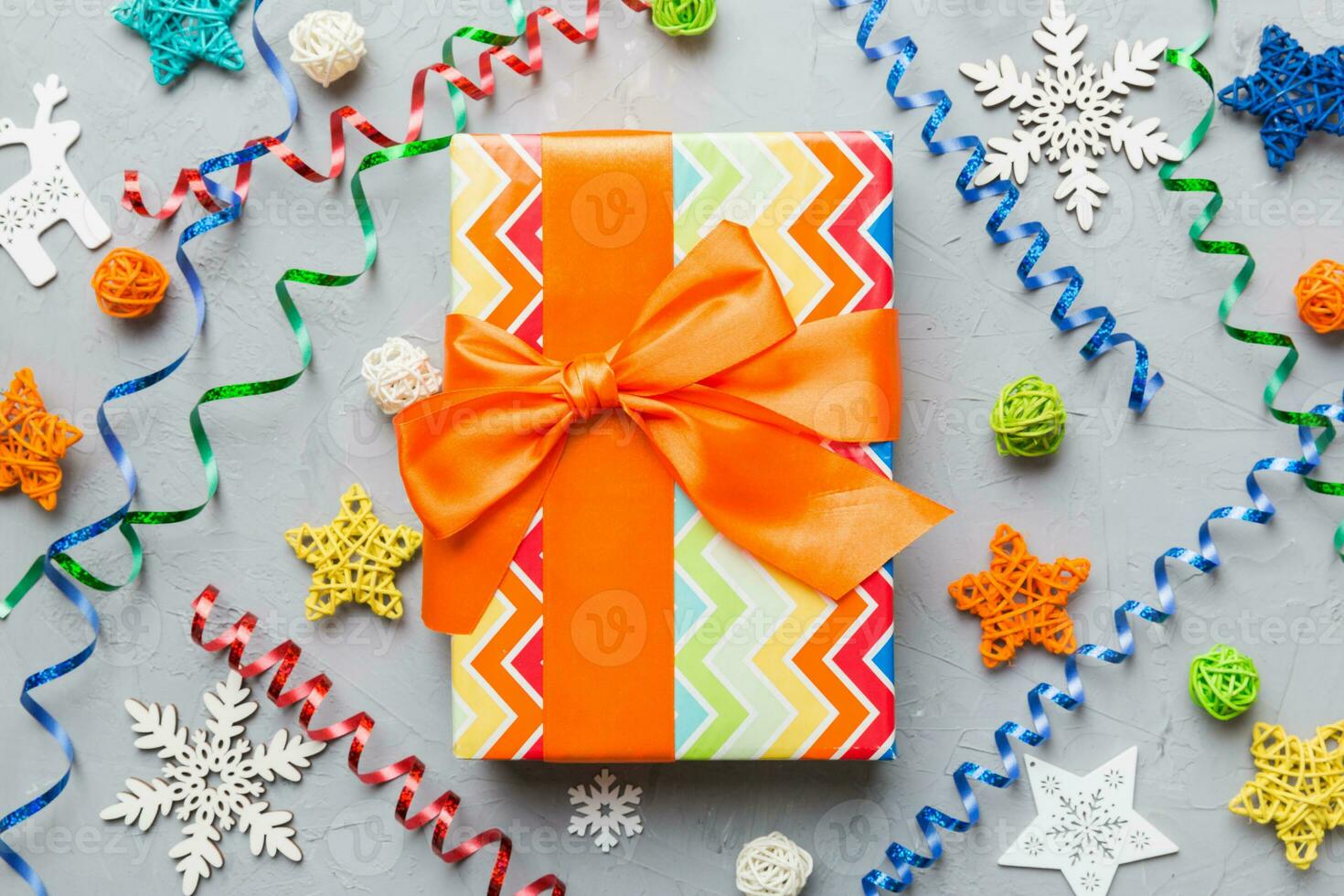 Christmas composition. Gifts box with new year decorations on colored background. Christmas, winter, new year concept. Flat lay, top view, copy space photo