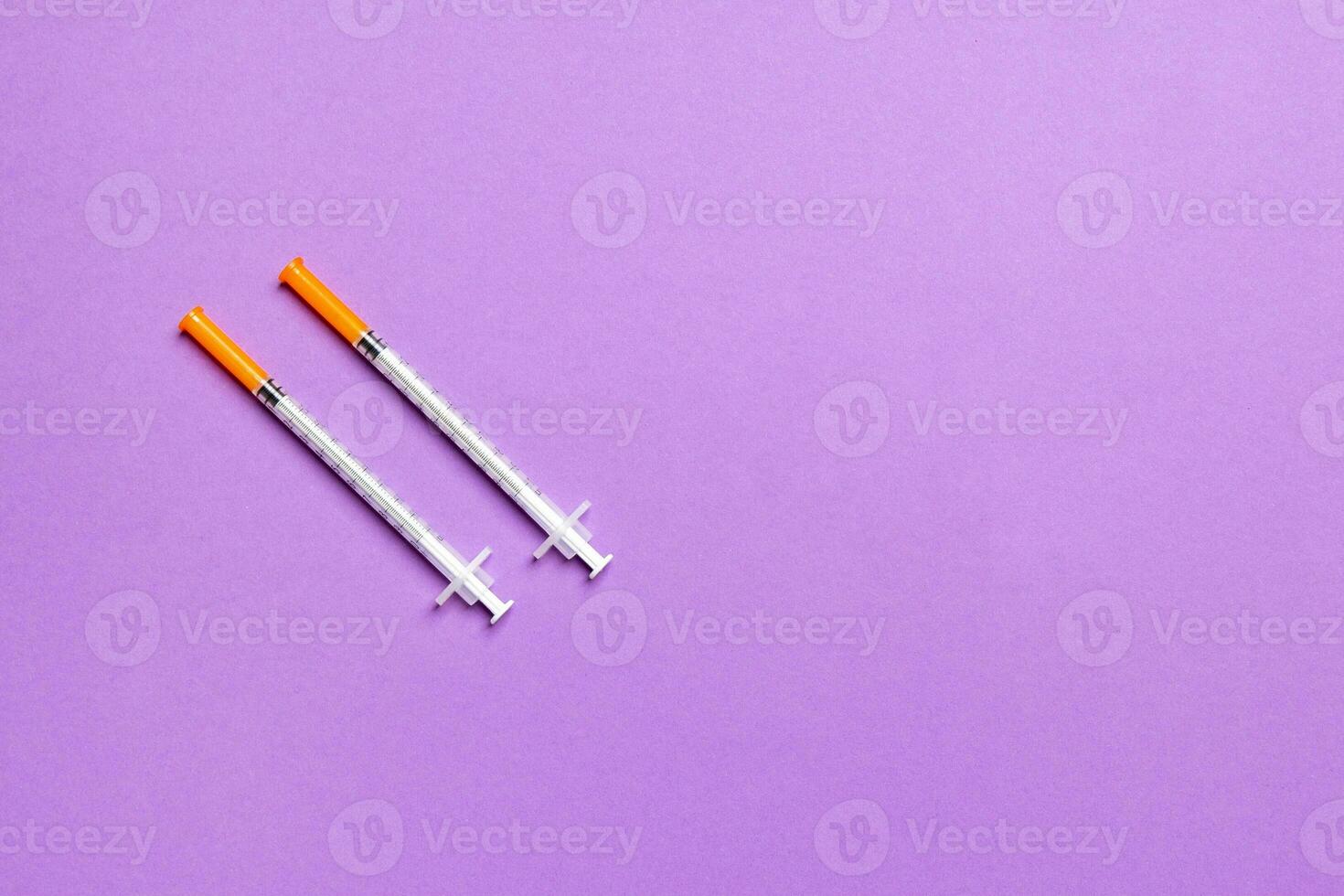 Top view of insulin syringes ready for injection on colorful background. Diabetic concept with copy space photo