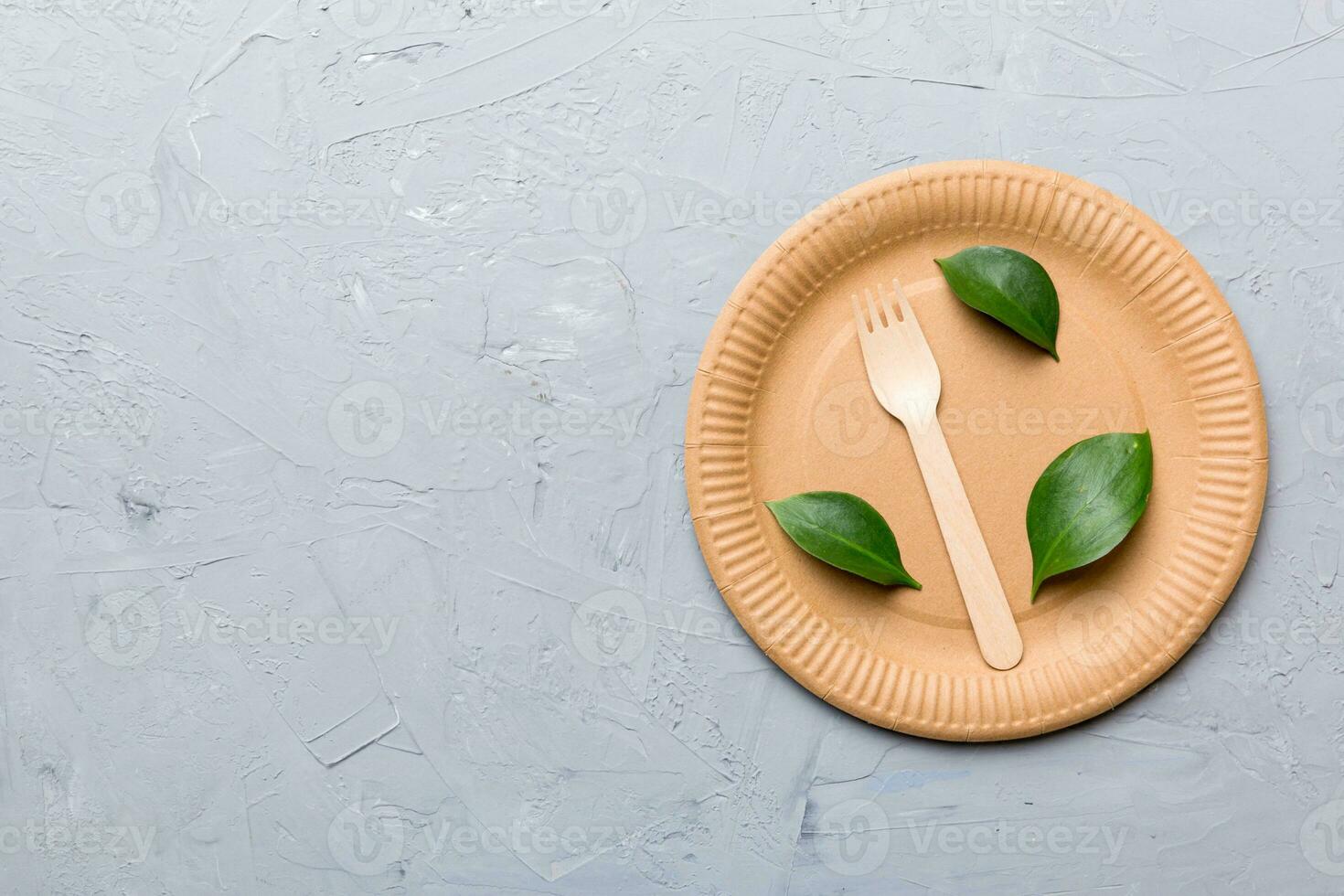 set of empty reusable disposable eco-friendly plates, cups, utensils on light white colored table background. top view. Biodegradable craft dishes. Recycling concept. Close-up photo