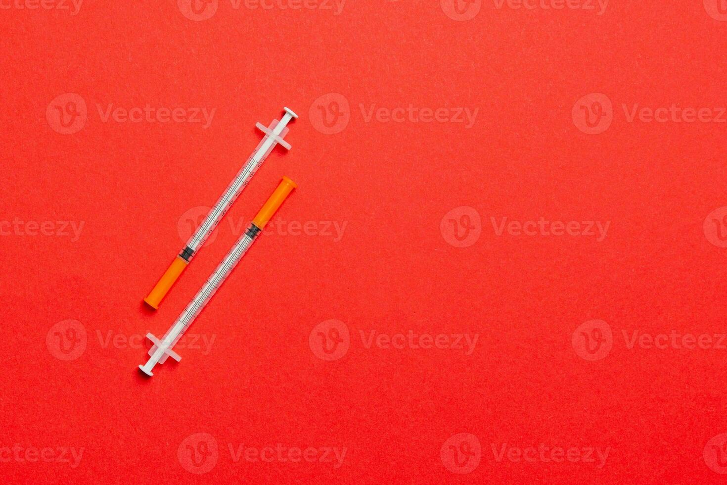 Top view of two insulin syringe at colorful background with copy space. High level of glucose concept photo