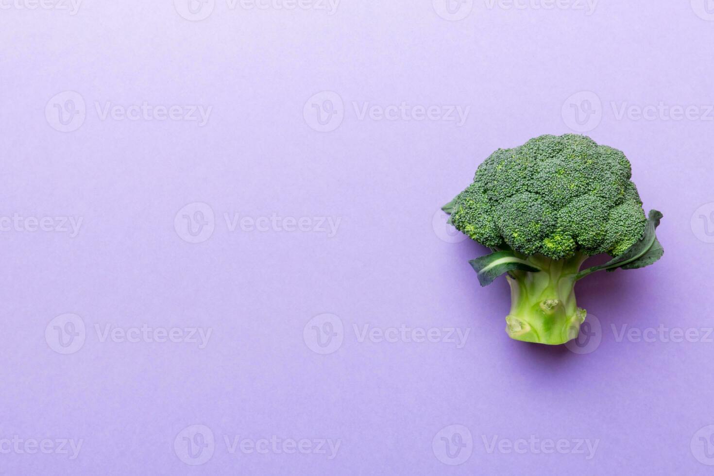 Top view fresh green broccoli vegetable on Colored background. Broccoli cabbage head Healthy or vegetarian food concept. Flat lay. Copy space photo