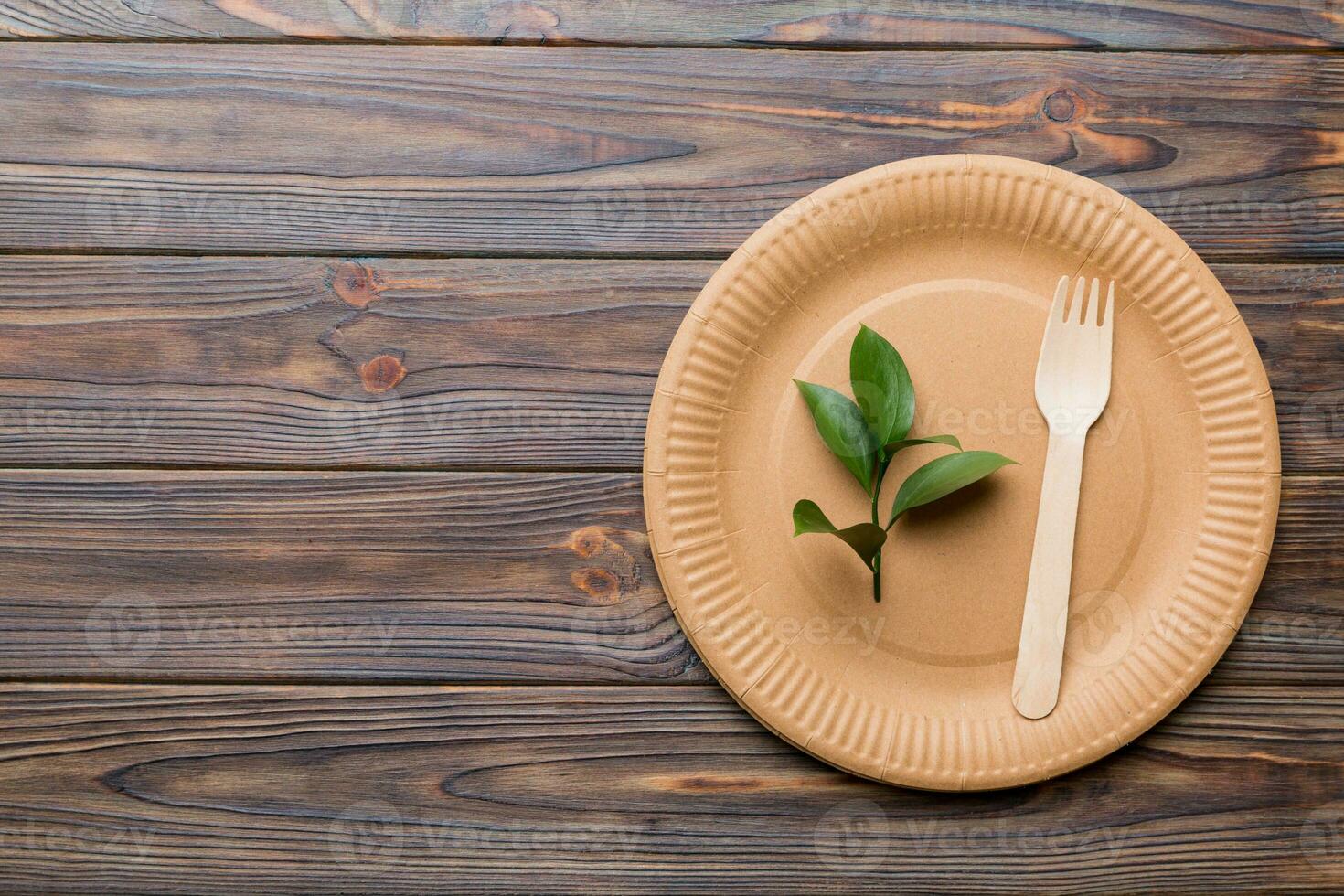 set of empty reusable disposable eco-friendly plates, cups, utensils on light white colored table background. top view. Biodegradable craft dishes. Recycling concept. Close-up photo