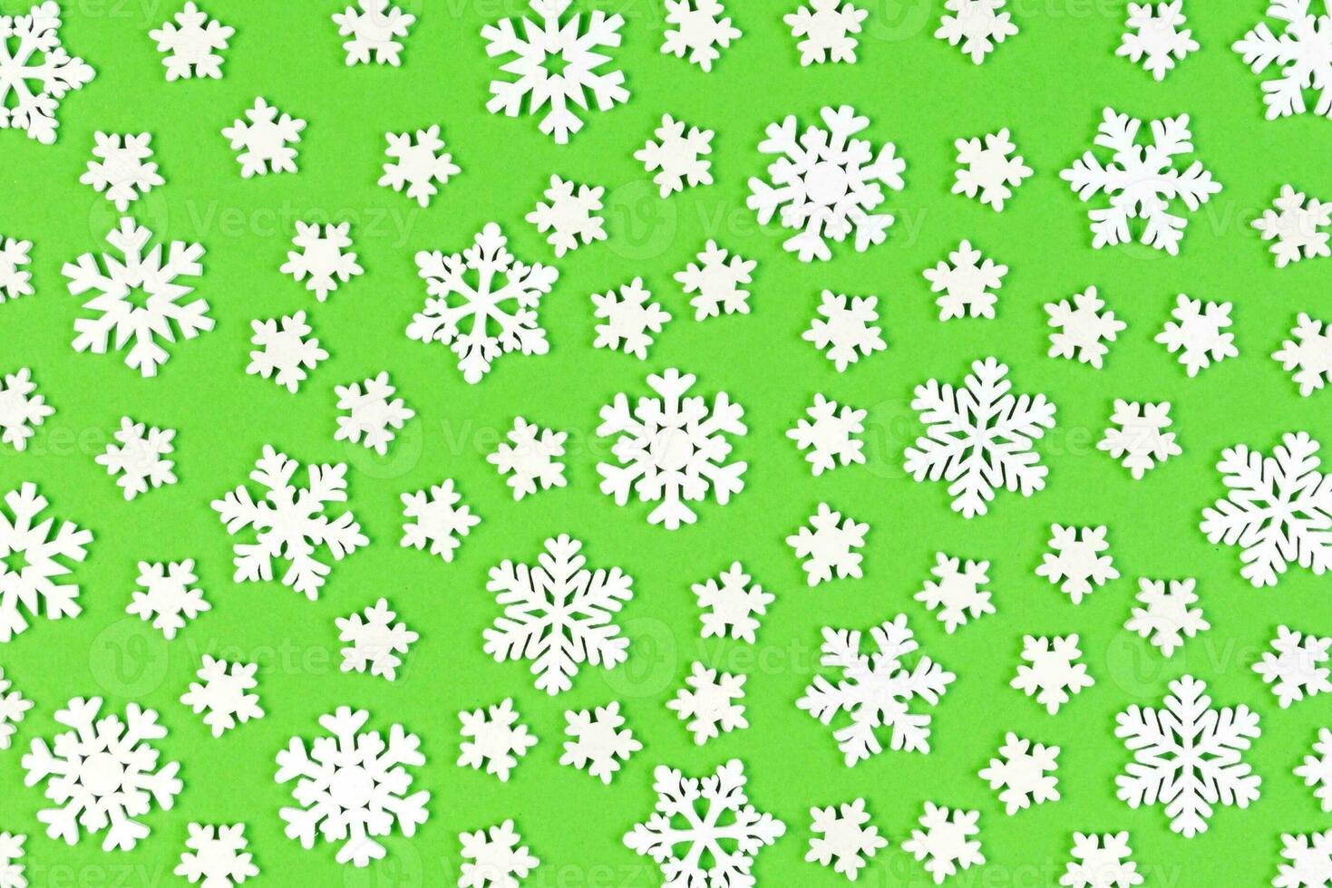 Set of white snowflakes on colorful background. Top view of Christmas ornament. New Year time concept with empty space for your design photo