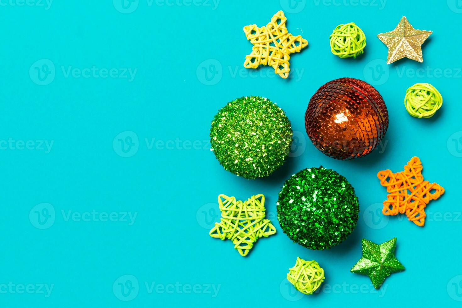 Creative set of New Year baubles and decorations on colorful background. Top view of Christmas time concept. Copy space photo