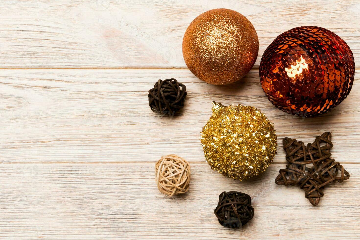 Top view of festive winter composition on wooden background with empty space for your design. Christmas baubles and decorations. New Year concept photo