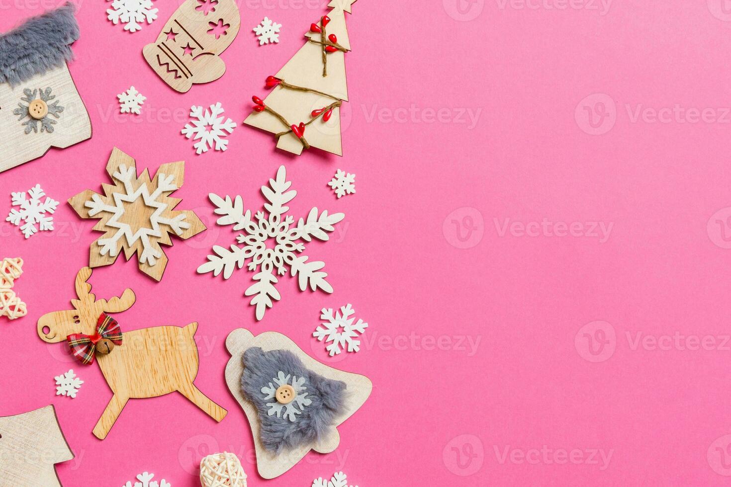 Top view of holiday decorations and toys on pink background. Christmas ornament concept with empty space for your design photo