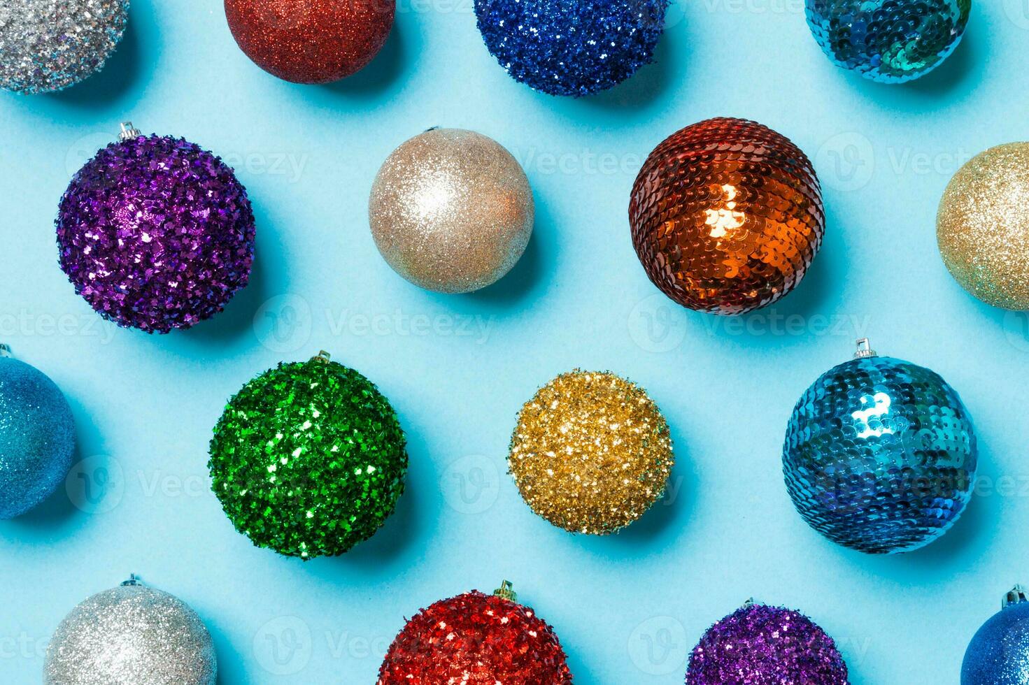 Top view of colorful Christmas balls on blue background. New Year time concept photo