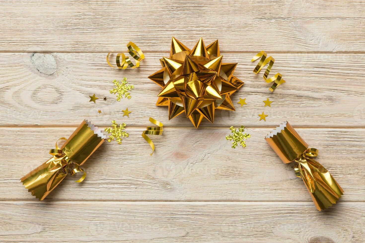 Christmas crackers with shiny confetti on color background, top view, copy space photo