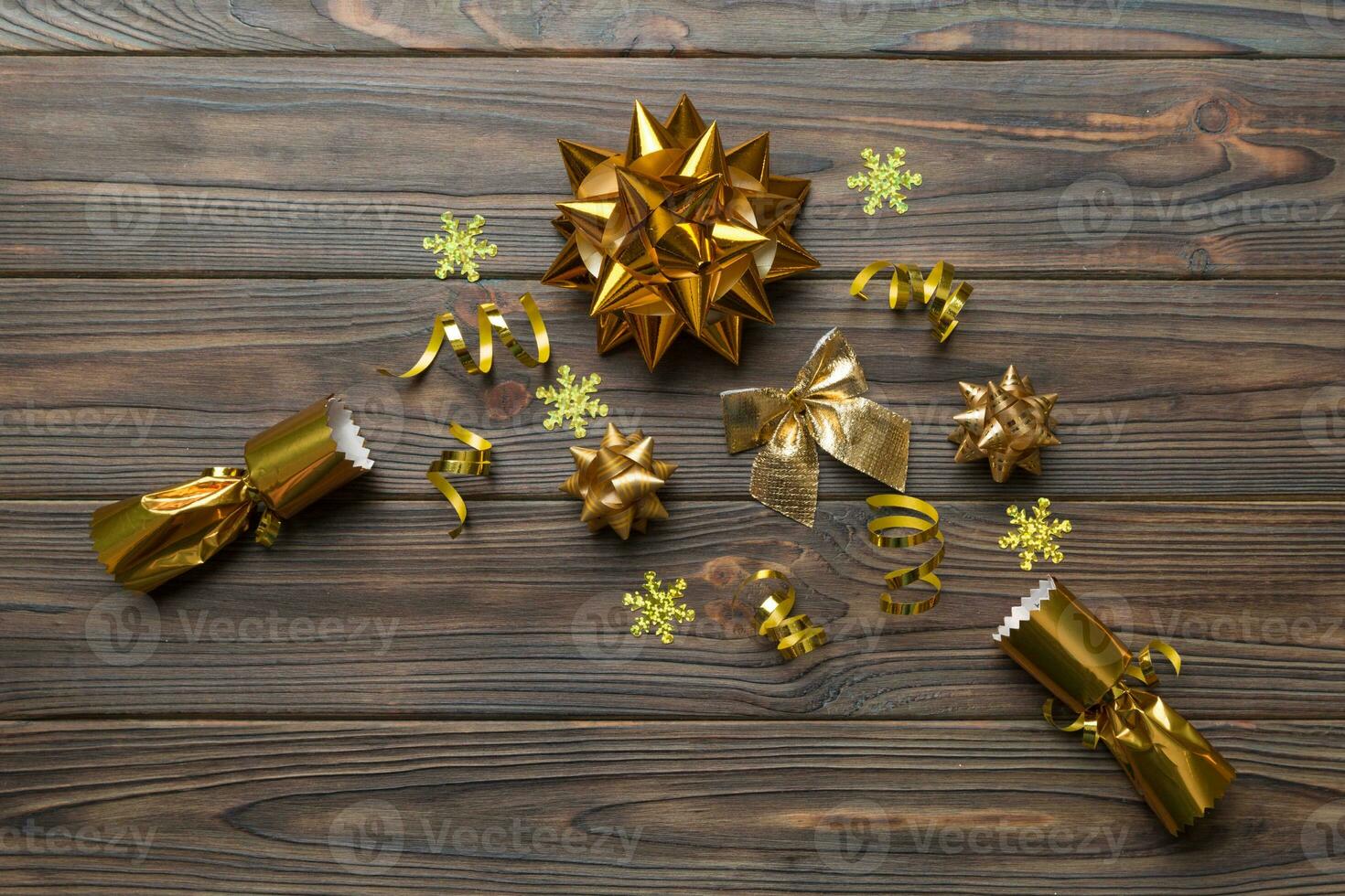 Christmas crackers with shiny confetti on color background, top view, copy space photo
