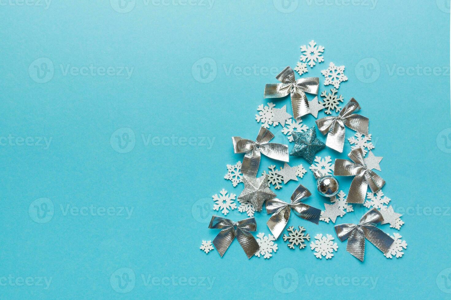 Christmas tree made from colored handmade ball decoration on colored background, view from above. New Year minimal concept with copy space photo