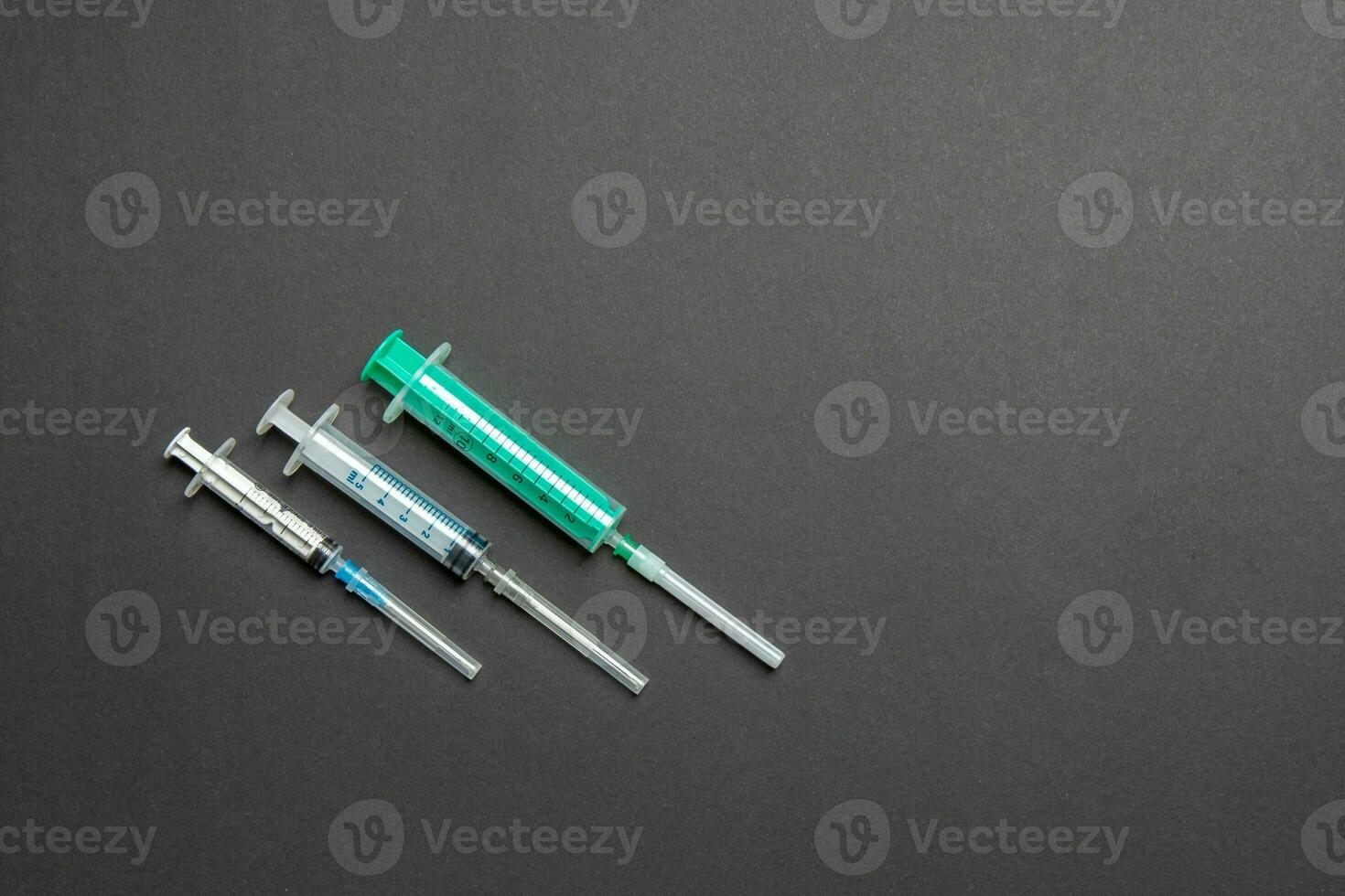 Top view of different syringes for injection on colorful background. Medical equipment concept with copy space photo