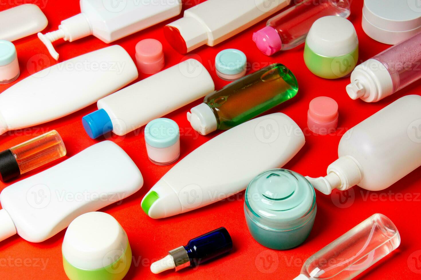 Close-up set of diffrent sized bottles and jars for cosmetic products on colored backgound. Face and body care concept with copy space photo