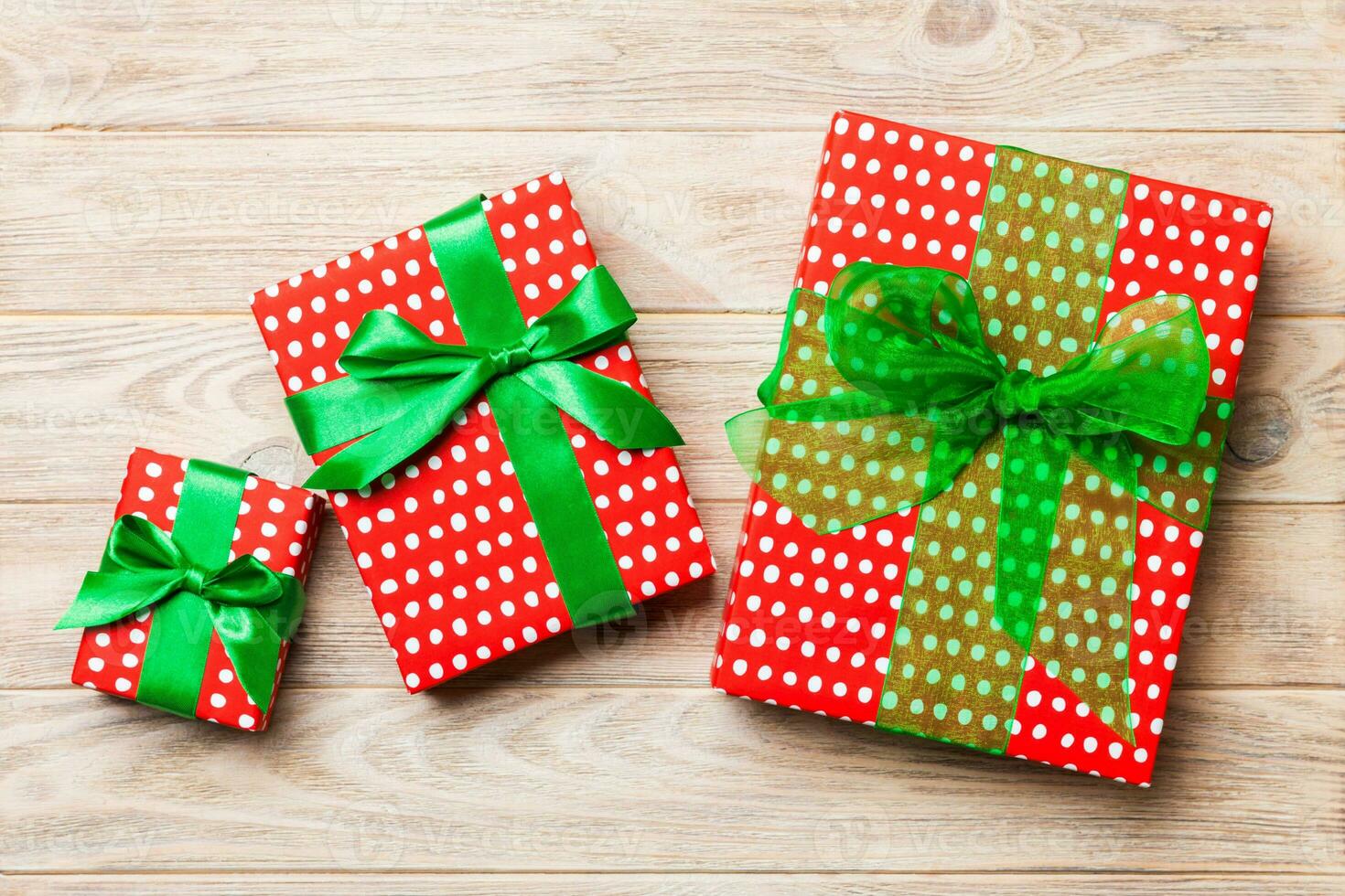 Beautiful gift box with a colored bow on the orange wooden table. Top view with copy space for you design. Christmas concept photo