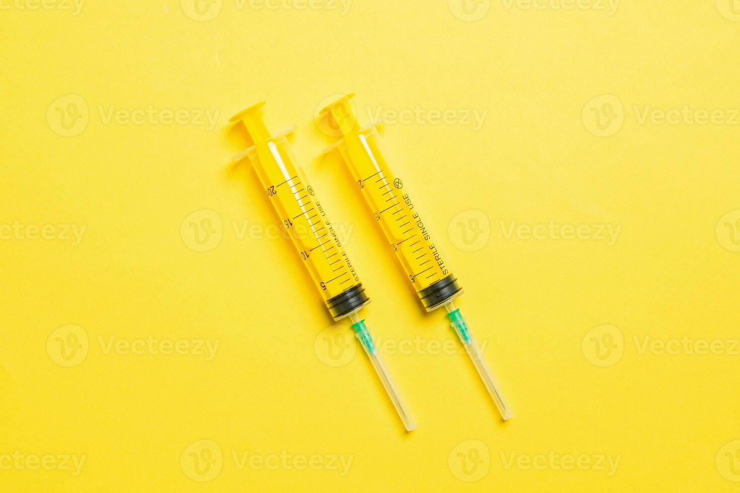 Top view of medical syringes on colorful background with copy space. Injection equipment concept photo