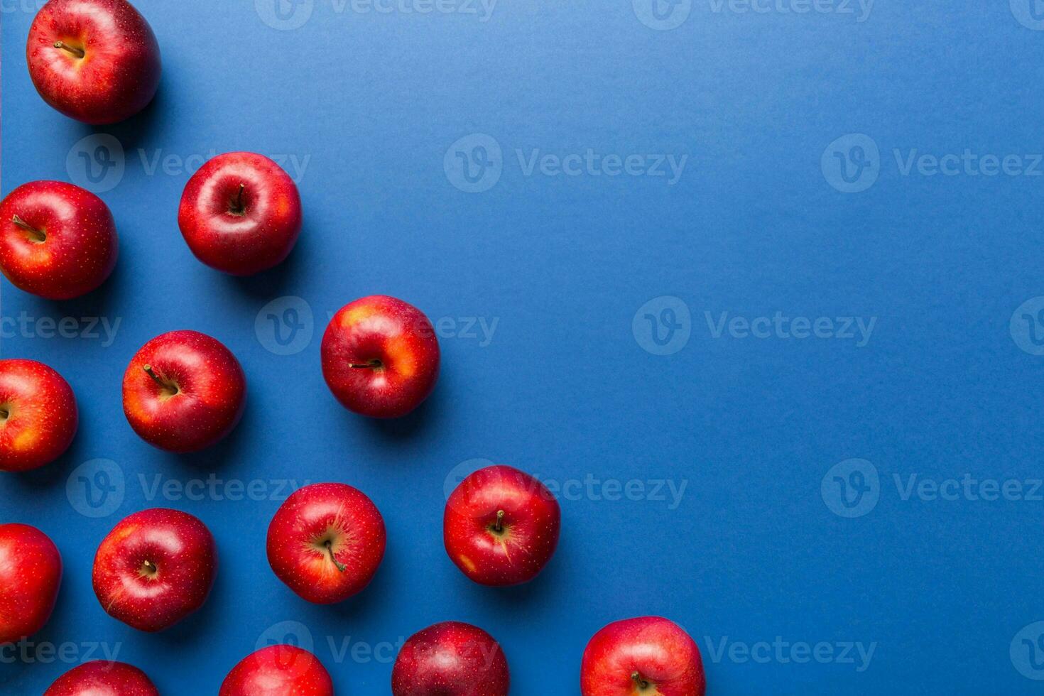 Many red apples on colored background, top view. Autumn pattern with fresh apple above view with copy space for design or text photo