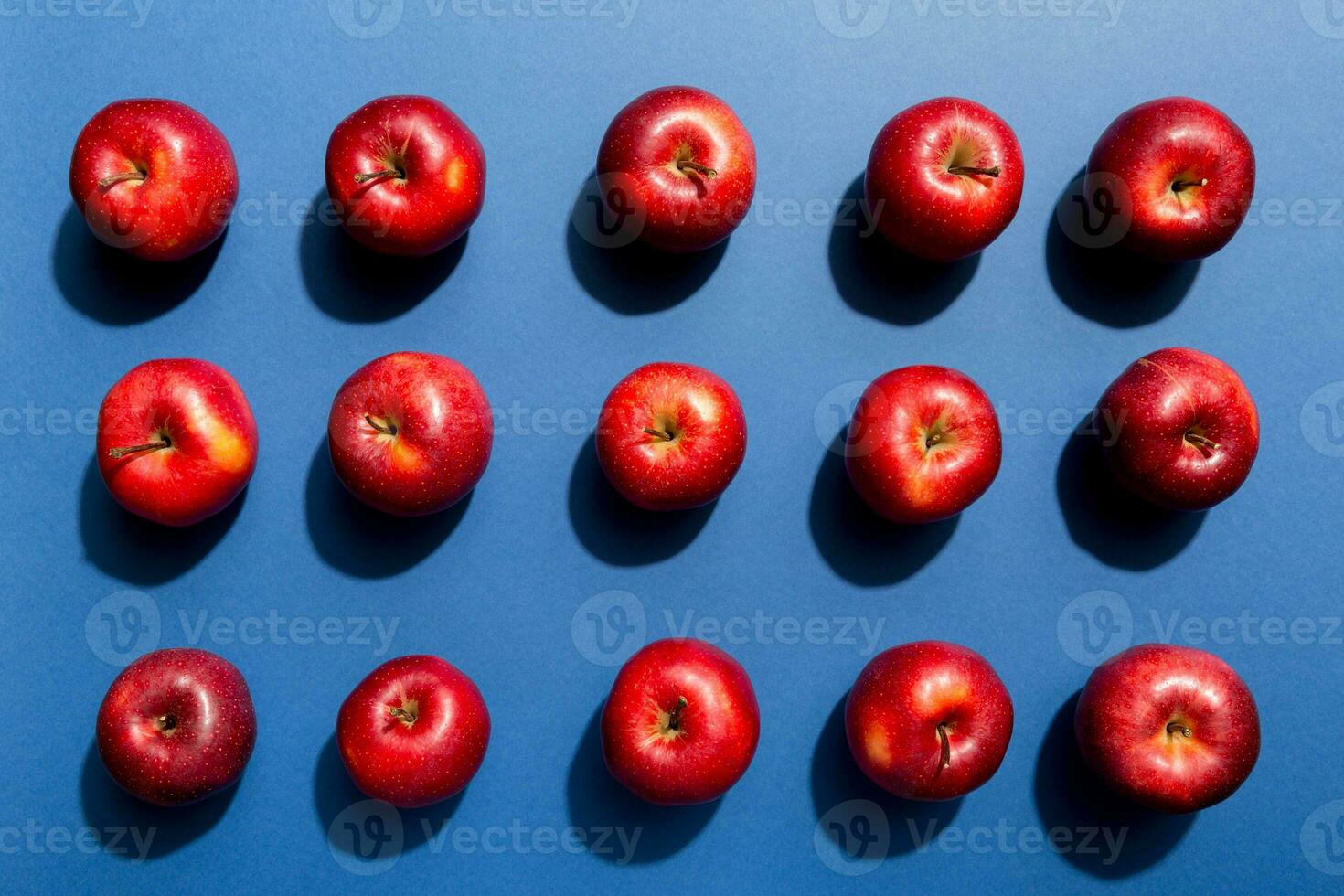 Many red apples on colored background, top view. Autumn pattern with fresh apple above view photo
