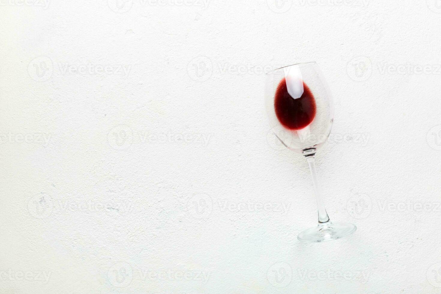 One glasses of red wine at wine tasting. Concept of red wine on colored background. Top view, flat lay design photo