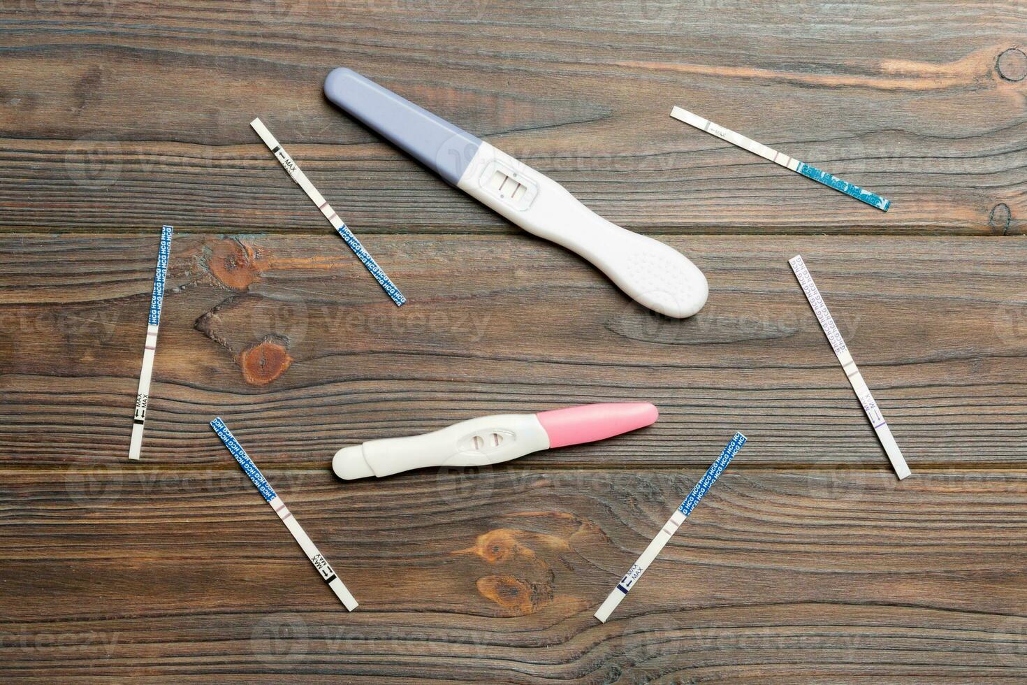 Colored Pregnancy test on wooden background, top view with copy space photo