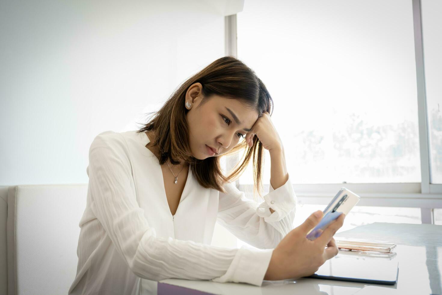 Beautiful asian business woman or working girl is stressed out a photo