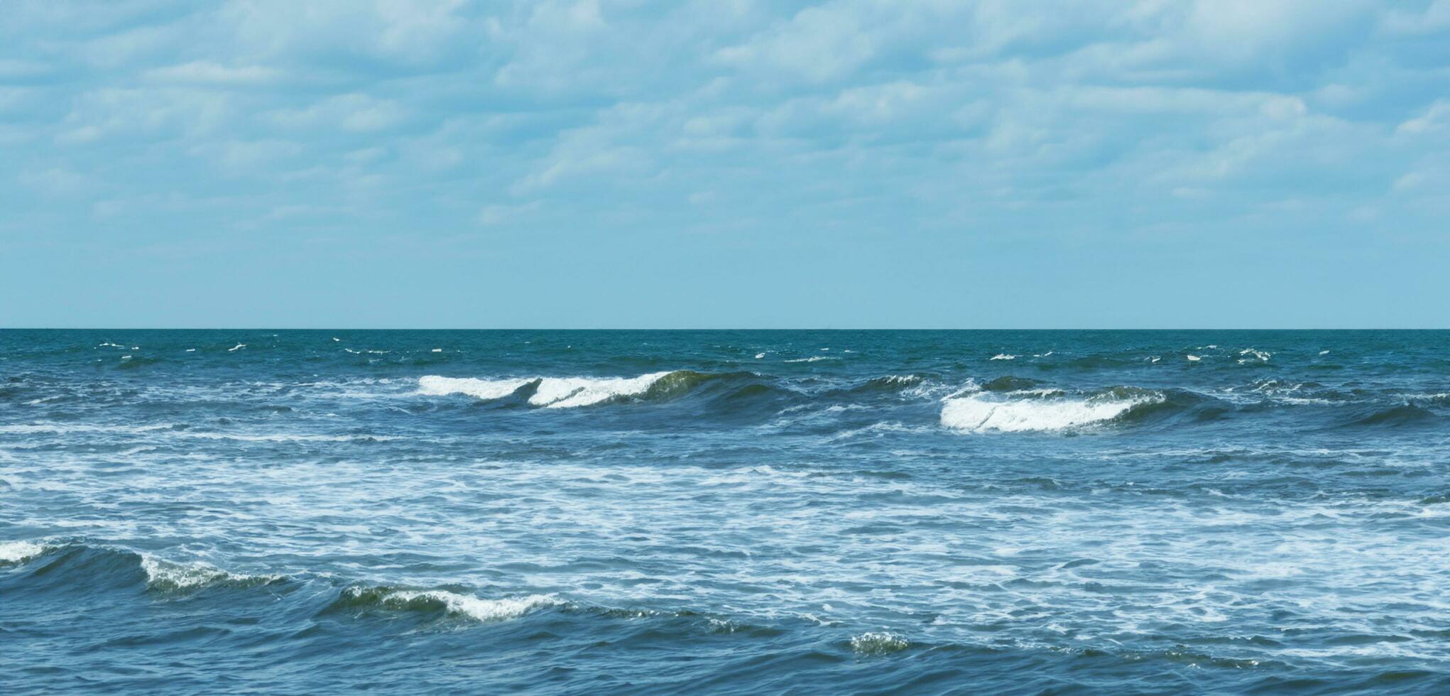 Calm ocean waves on a clear day sea and horizon image of sea waves and sky photo