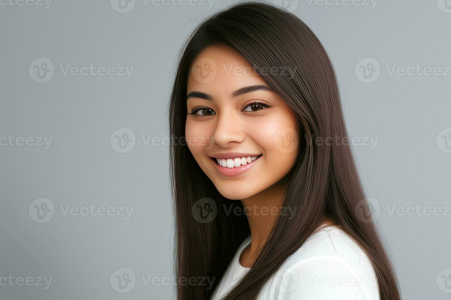 Closeup photo portrait of a beautiful young asian woman smiling with clean teeth on gray background.generative ai.