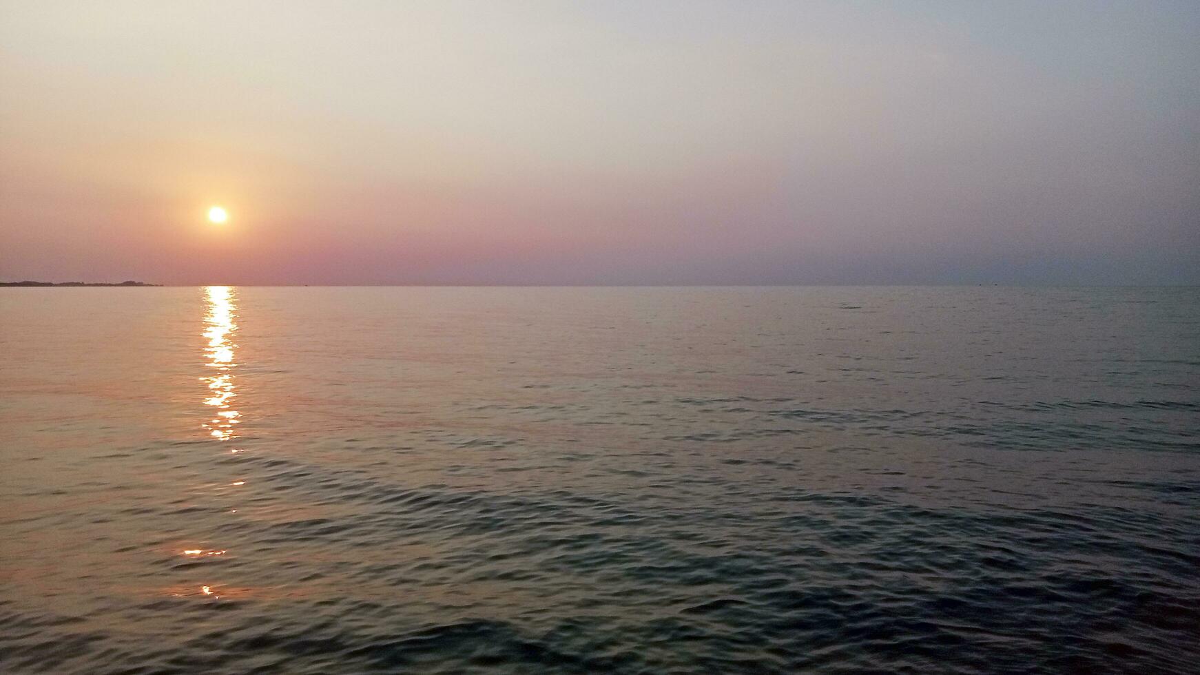 Sunset golden moment, seen from the coast of Central Java, Indonesia photo