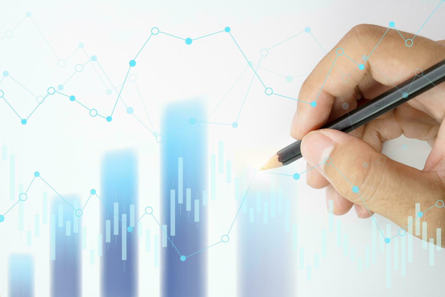 Hand holding pencil points to the graph analysis on monitor screen, Economic and financial concept, Business concept - Financial graphs drawn with pencil. photo