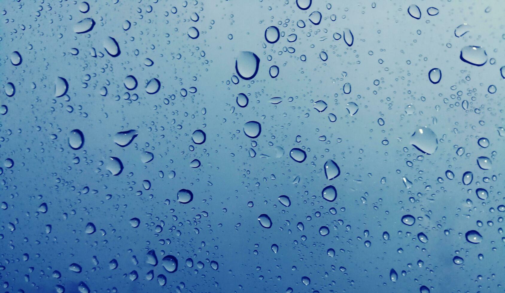 Beautiful raindrops on a window, Raindrops Or Vapor Trough on the glass, Abstract of raindrops on the mirror with a colored background. Drops of water - Image photo