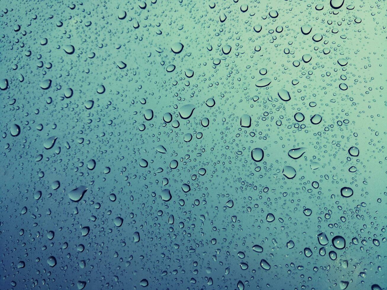 Beautiful raindrops on a window, Raindrops Or Vapor Trough on the glass, Abstract of raindrops on the mirror with a colored background. Drops of water - Image photo