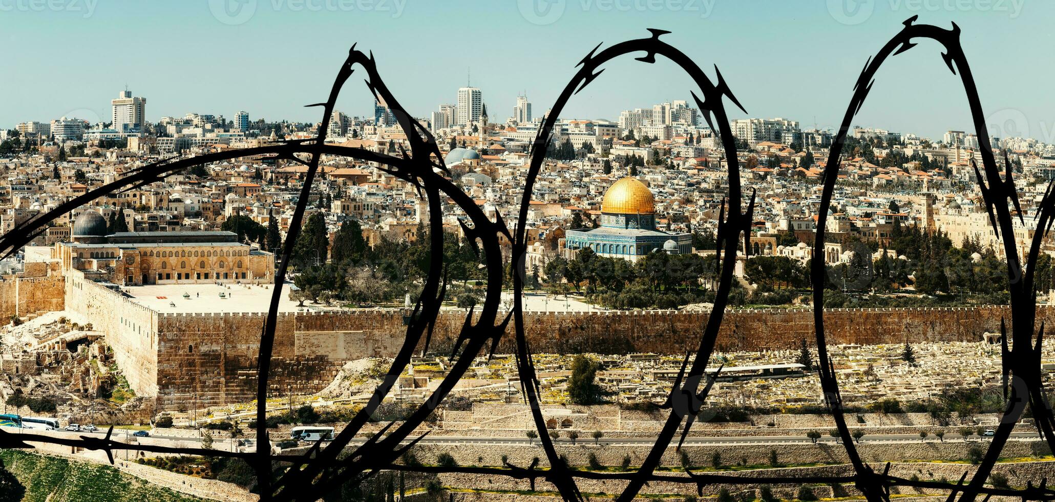 View of Jerusalem Old city and the Temple Mount, Dome of the Rock and Al Aqsa Mosque from the Mount of Olives in Jerusalem, Israel superimposed with barbed wire photo