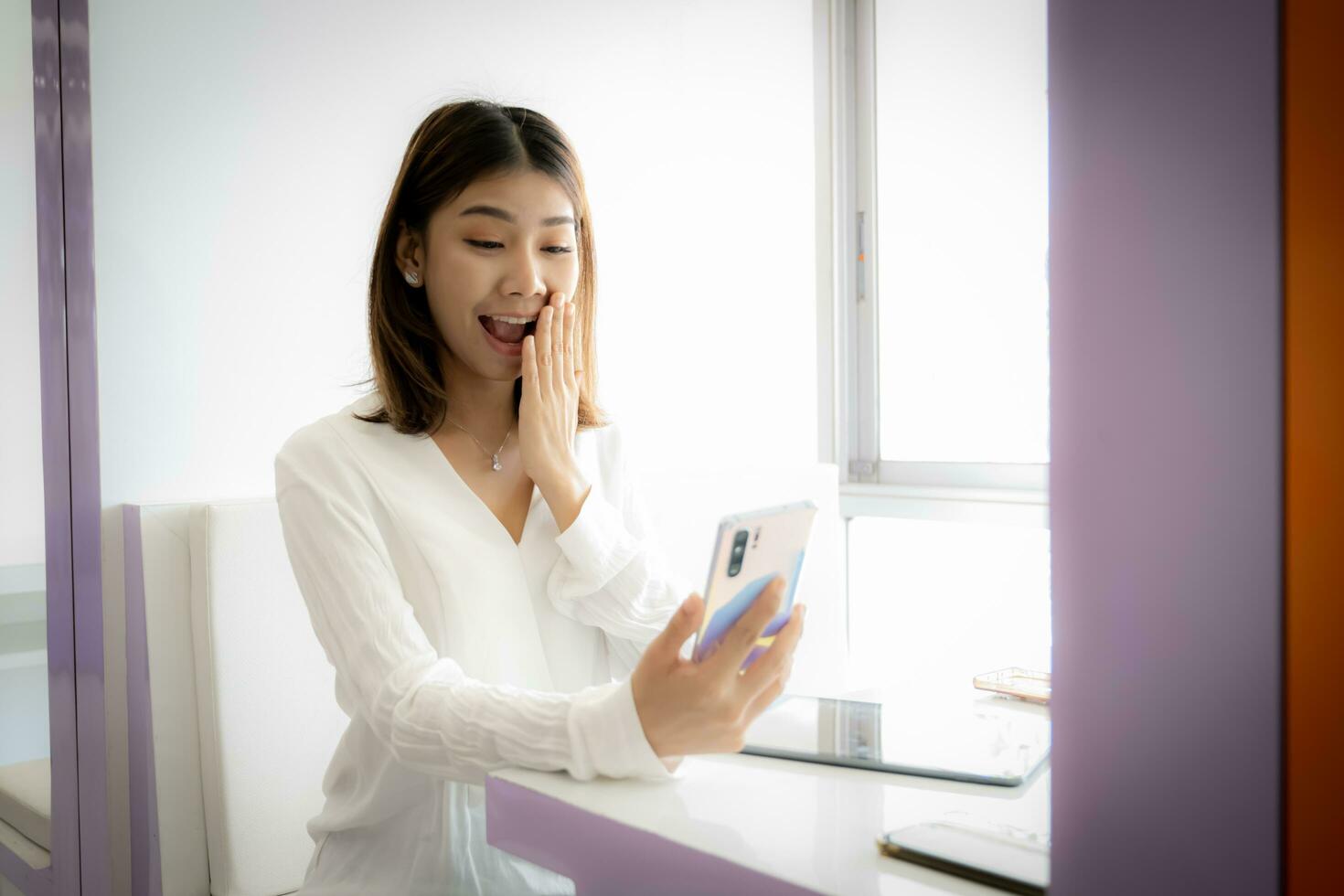 Beautiful asian businesswoman excited about big bonus at work. photo
