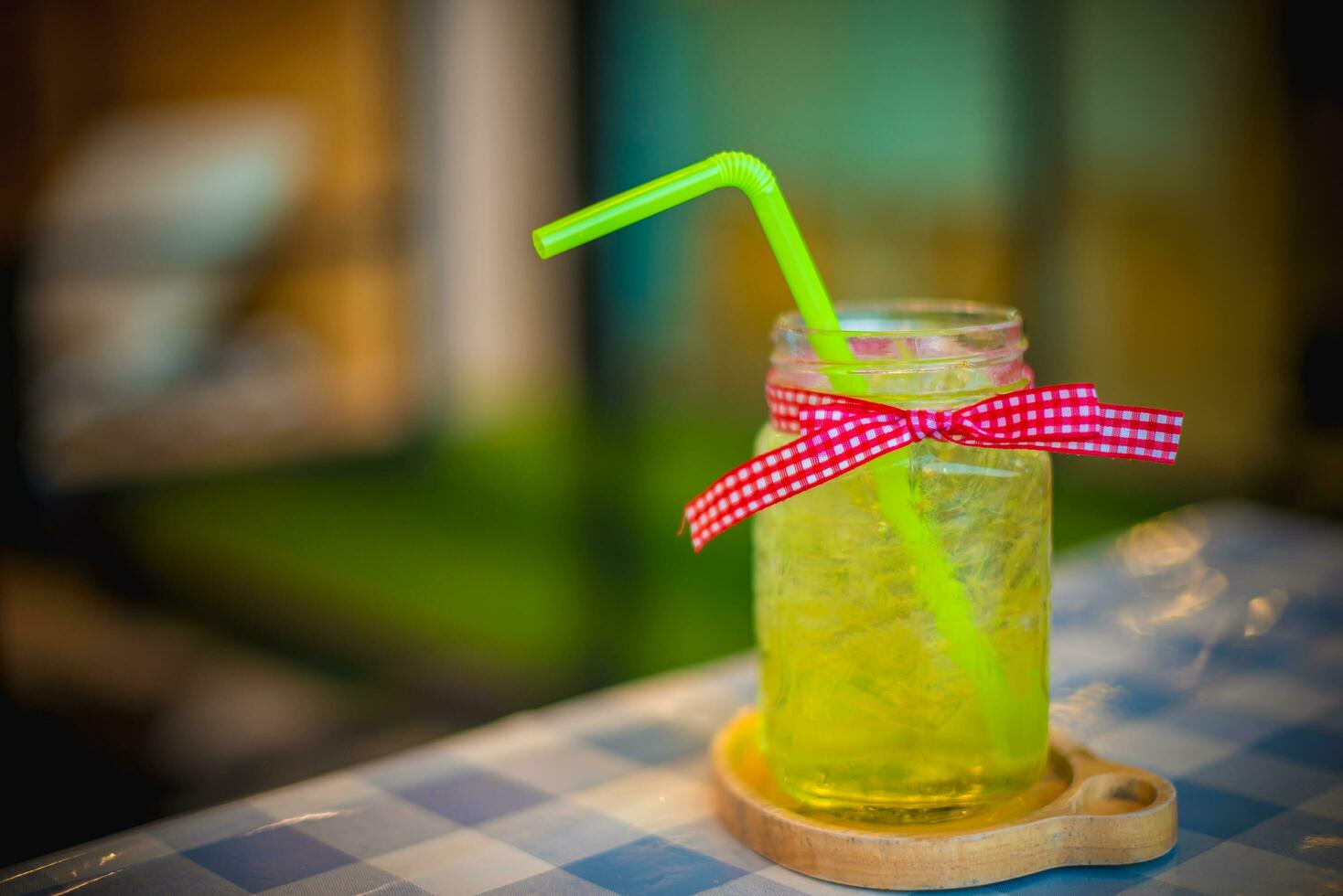 Iced honey and lime soda, Iced green tea mixed with honey lemon juice and decorated with a polka dots pink bow tie, Refreshing drink. photo