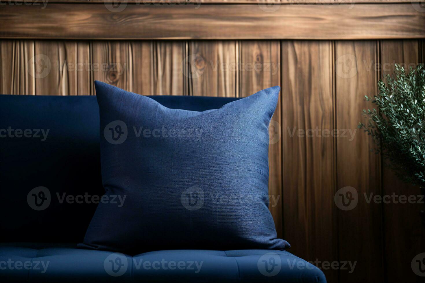 A deep blue cushion on a navy blue sofa against a textured wood accent wall. A bright and cozy corner of the interior, AI Generated. photo