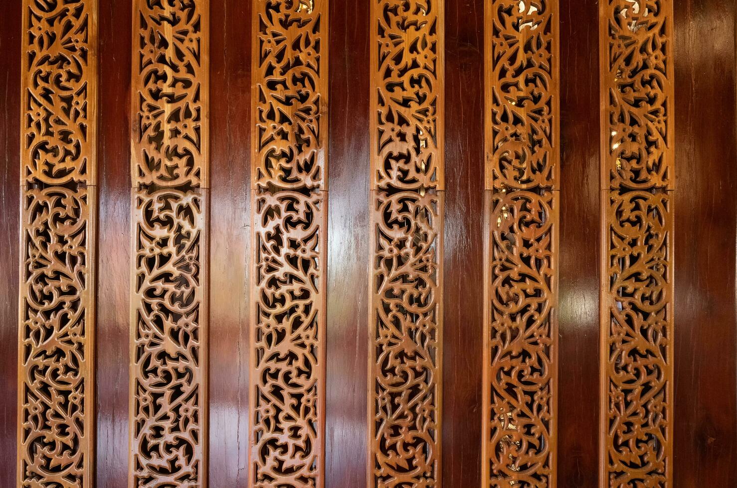 The red walls are decorated with beautiful wooden patterns. photo