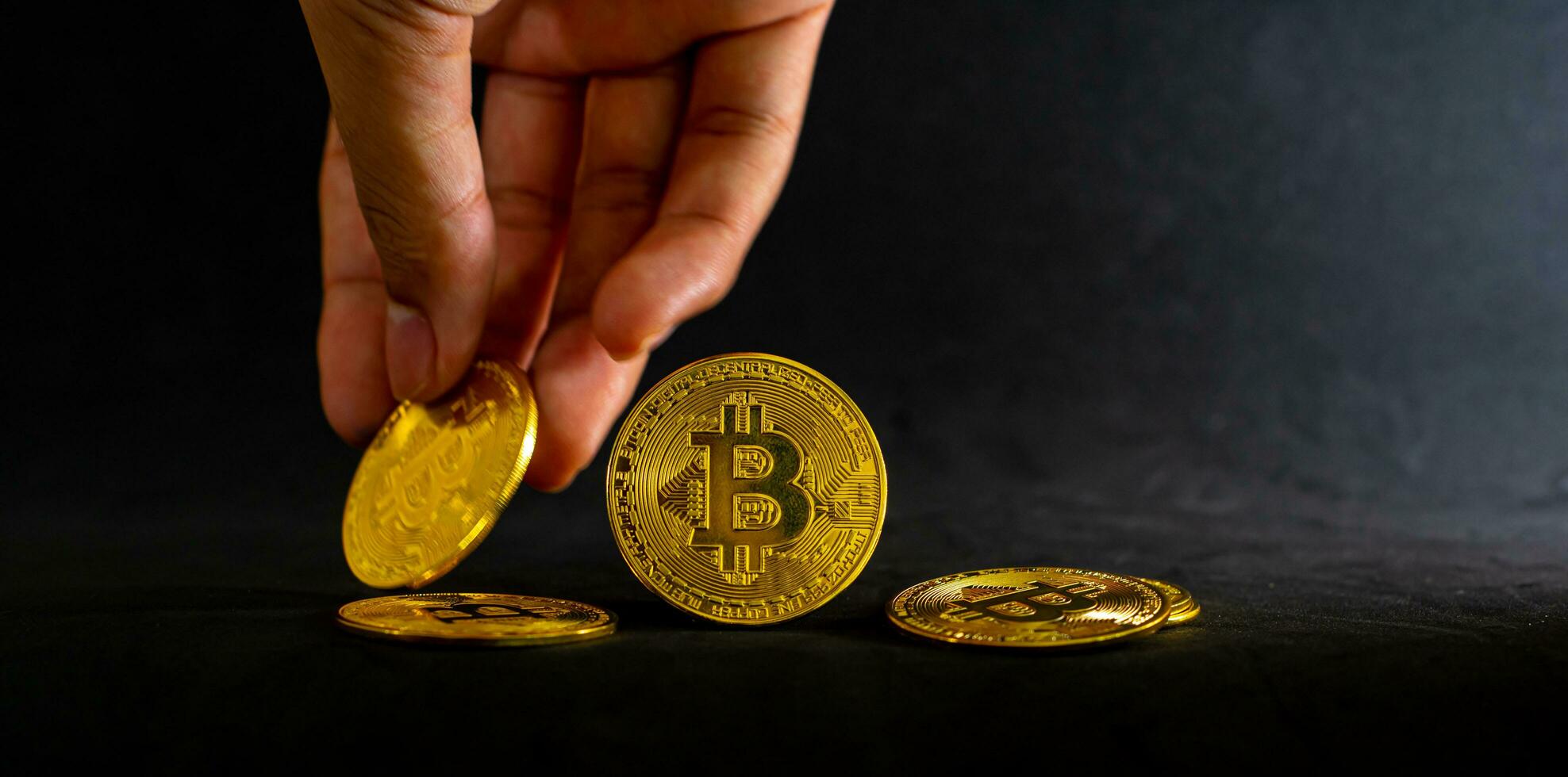 Hand  hold golden bitcoin, Bitcoin  with Black background. Online shopping and Crypto currency concept. photo