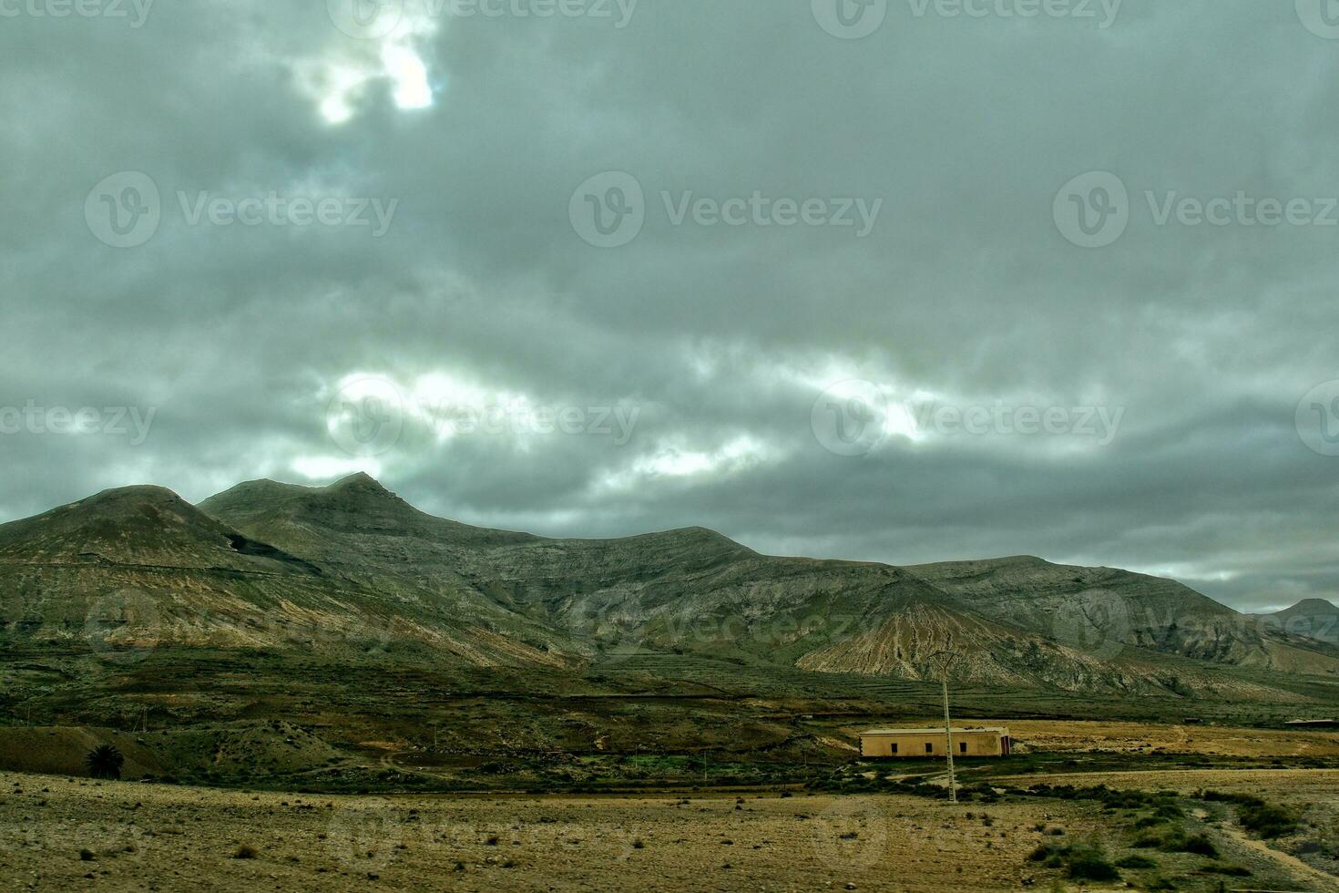 empty mysterious mountainous landscape from the center of the Canary Island Spanish Fuerteventura with a cloudy sky photo