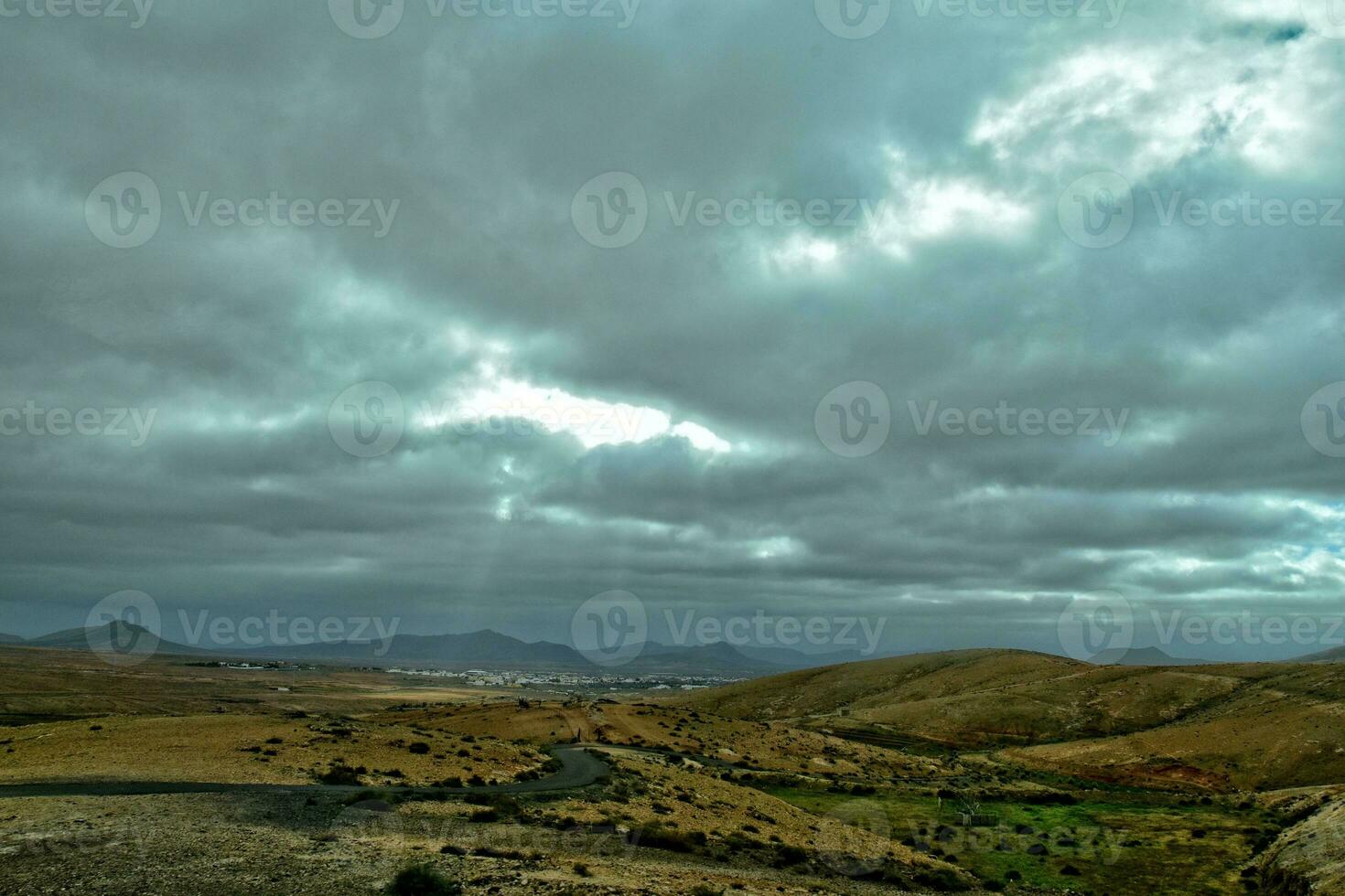 empty mysterious mountainous landscape from the center of the Canary Island Spanish Fuerteventura with a cloudy sky photo