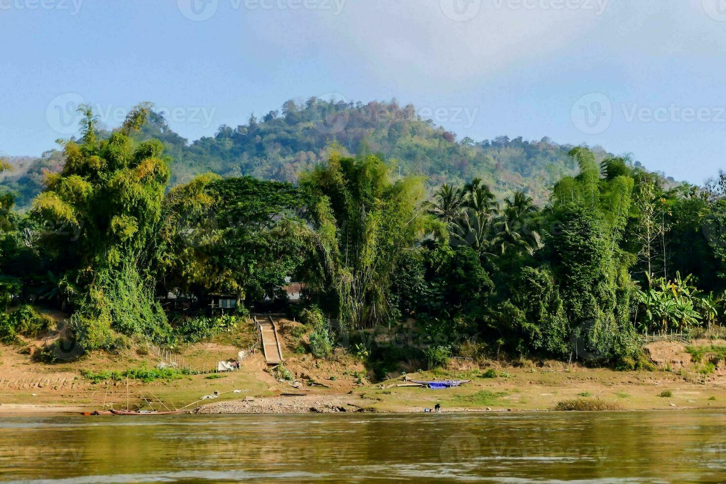 a river with a mountain in the background photo