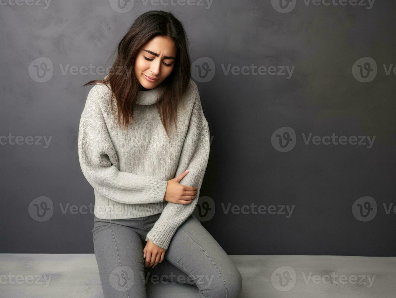 Mexican woman appears to be in pain on grey background AI Generative photo